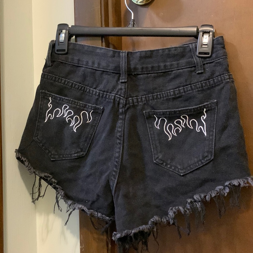 SHEIN high waisted black denim distressed shorts with white fire pattern pockets
